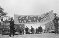 African American men carrying a banner stating freedom for all people