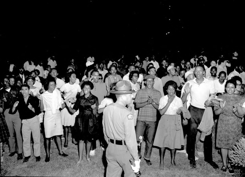 A group of African American protesters chanting and clapping on the lawn of the Executive Mansion in Raleigh.