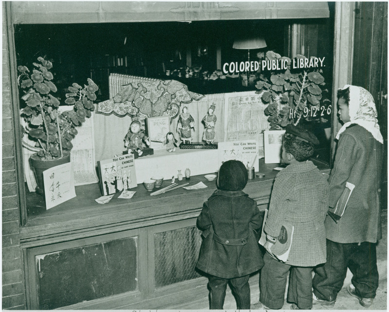 Black children look at the display window of the Market Street Branch Library in Asheville.