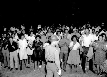 A group of African American protesters chanting and clapping on the lawn of the Executive Mansion in Raleigh.