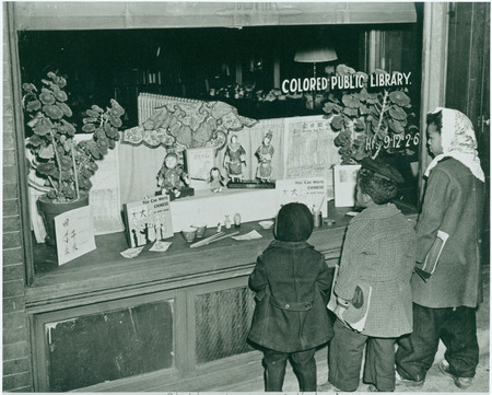 Black children look at the display window of the Market Street Branch Library in Asheville.