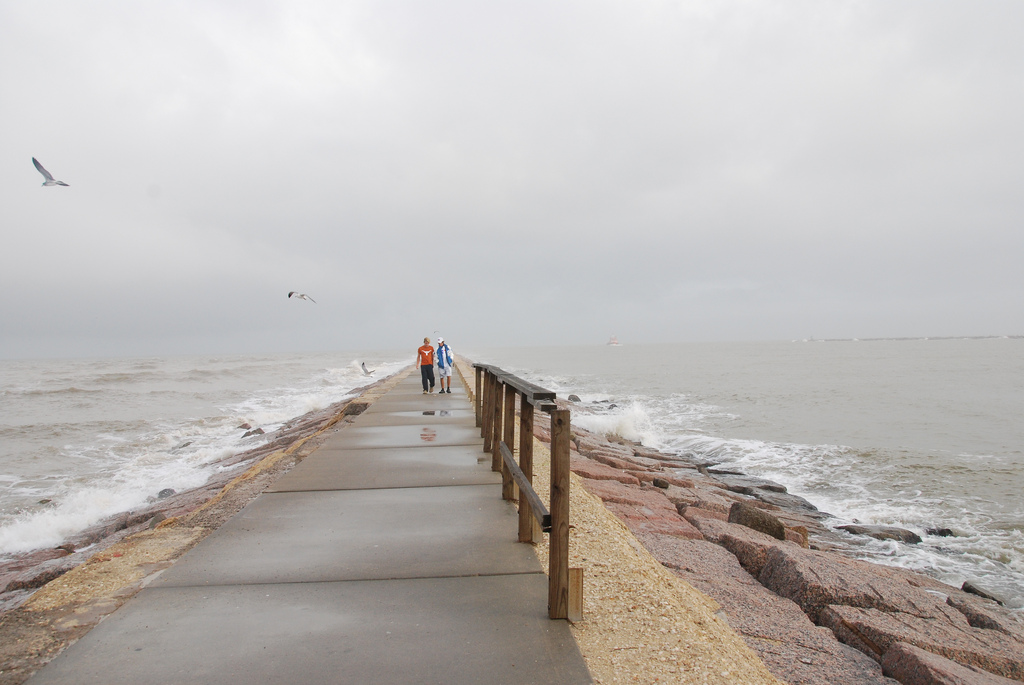 two people walking on a jetty