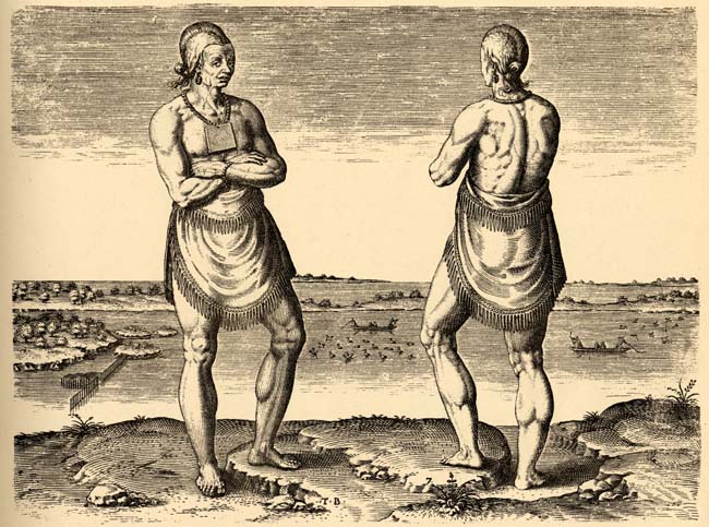 Two indigenous people stand beside each other.