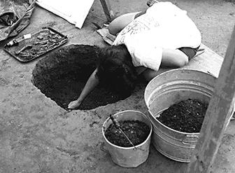 An ancient storage pit being excavated by archaeologists