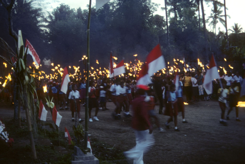 School children with flags and torches depart Independence Day ceremonies