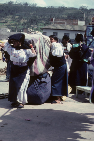 Loading a bundle at the market in Otavalo, Ecuador