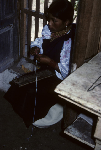 Weaving a bracelet in Otavalo, Ecuador