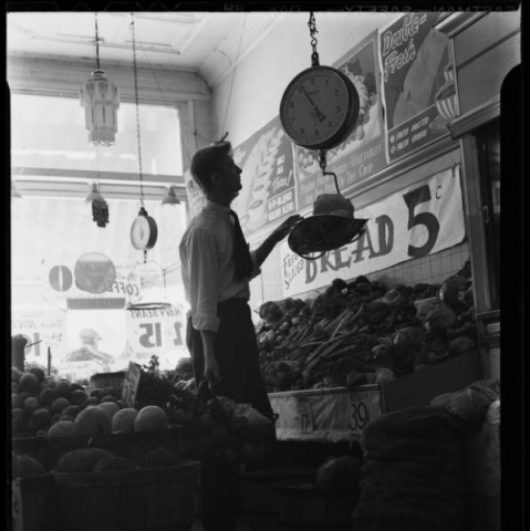 Dan Martin weighing produce in grocery store 