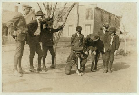 Boys playing a game of marbles