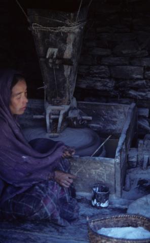 A woman milling corn flour