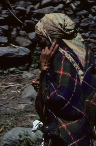 Pilgrim with bag slung on her back