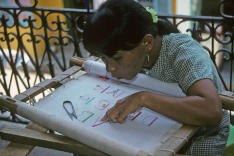Woman doing embroidery at handicraft workshop in Hoi An