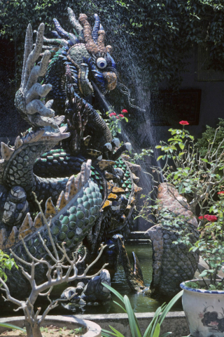 Dragon and fish statues in garden fountain of Chinese Fukian hall at Hoi An