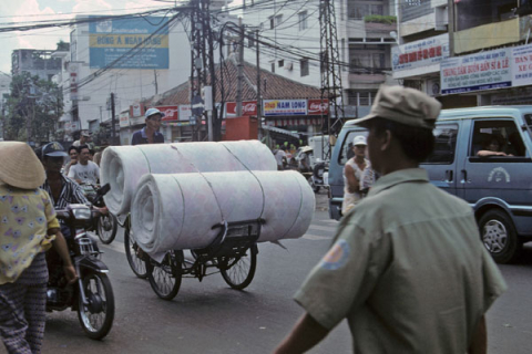 Mattress rolls carried on bicycle rickshaw in Ho Chi Minh City's Chinatown