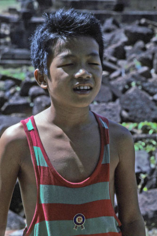 Portrait of boy with eyes closed wearing striped sleeveless shirt at Siem Reap