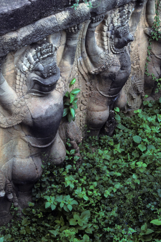 Carved stone reliefs of Garuda supporting Elephant Terrace at Angkor Thom
